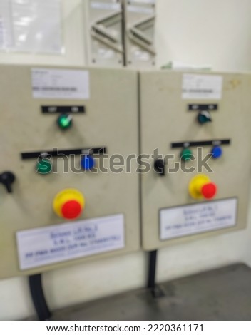 Blurred picture of the lift construction control panel box for the way up and down and there is an emergency stop of the safety system
