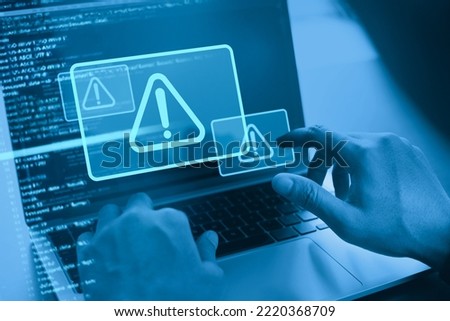 Cyber security concept. Man using computer with system hacked alert due to cyber attack on computer network. Data Protection. Internet virus cyber security and cybercrime Royalty-Free Stock Photo #2220368709