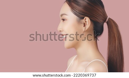 Side face of Beautiful Asian girl isolated on pink background with copy space. Royalty-Free Stock Photo #2220369737