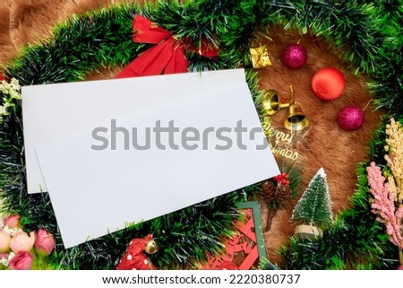A Blank greeting card with christmas season themed decorations. A blank white paper around a lot of christmas ornaments, colorful gift boxes. Blank space to fill. Christmas paper mockup image