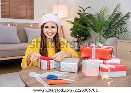 Excited woman opening presents at Christmas
