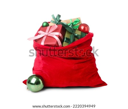 Santa Claus bag full of gifts and decorations on white background