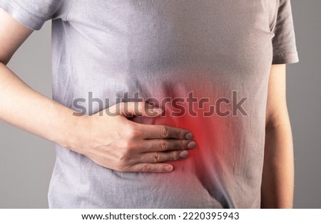 Liver pain and disease concept. Problem, red inflammation in abdominal area. Chronic illness, cirrhosis. High quality photo Royalty-Free Stock Photo #2220395943