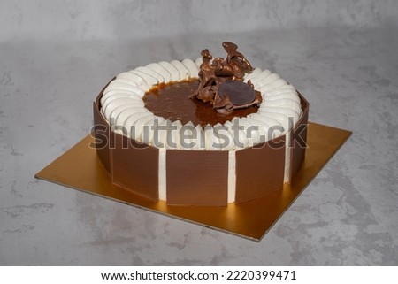 Chocolate and caramel cake set in neutral background.