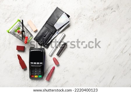 Shopping cart, decorative cosmetics, payment terminal, wallet and credit cards on light background