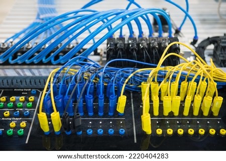 Control panel with blue and yellow wires Royalty-Free Stock Photo #2220404283