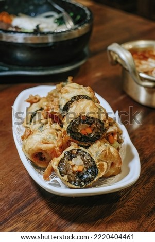 A plate of Korean cuisine that resembles sushi known as Gim Mari with blurred background