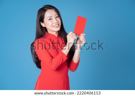 Photo of young Vietnamese woman wearing red ao dai Royalty-Free Stock Photo #2220406153