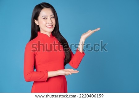 Photo of young Vietnamese woman wearing red ao dai Royalty-Free Stock Photo #2220406159