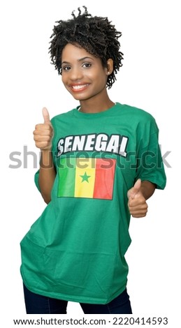 Happy female football fan from Senegal with green jersey isolated on white background for cut out