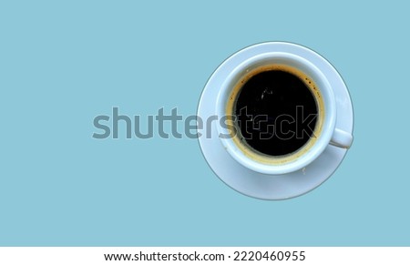 Coffee to drink after roasting coffee beans and pouring the ground or ground powder, White coffee cup top view closeup isolated on blue background.