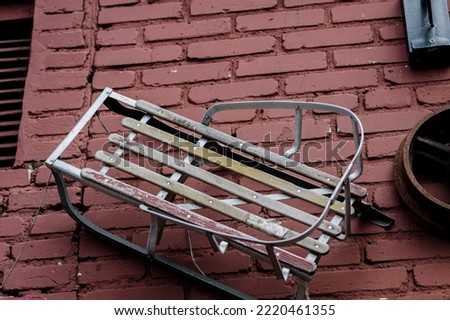 vintage wooden sled on brick wall. antique sledge