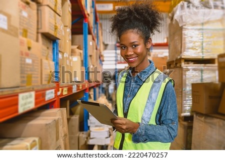 woman worker black African girl teen working in cargo warehouse inventory employee staff portrait happy smile Royalty-Free Stock Photo #2220470257