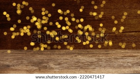 Empty Wooden table  in front of abstract blurred festive light background.  Photo. Christmas background Royalty-Free Stock Photo #2220471417