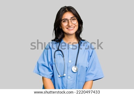 Young nurse Indian woman isolated happy, smiling and cheerful.