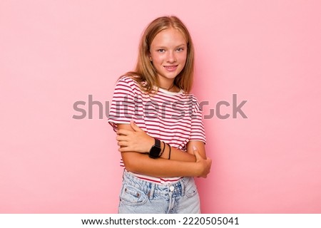 Caucasian teen girl isolated on pink background happy, smiling and cheerful.