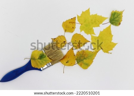 Blue construction brush and fall foliage