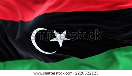 Close-up view of Libya National flag waving. The State of Libya is a State of North Africa. Fabric textured background. Selective focus