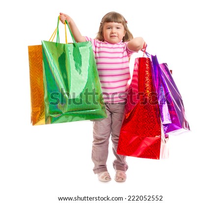 Little smiling girl with bags isolated