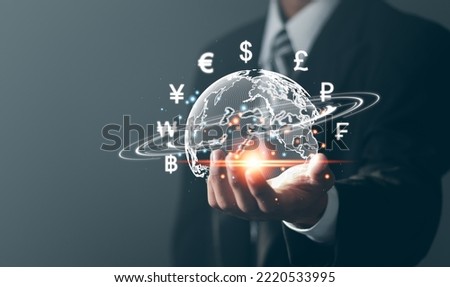 Online banking interbank payment concept. Businessman with virtual global currency symbols in hand. Money transfers and currency exchanges between countries of the world.  Royalty-Free Stock Photo #2220533995