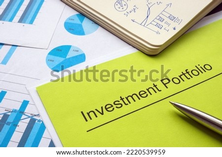 Investment portfolio and report with charts and graphs. Royalty-Free Stock Photo #2220539959