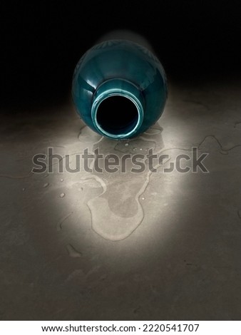 a dark green vase dropped on the table