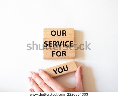 Our service for you symbol. Wooden blocks with words Our service for you. Beautiful white background. Businessman hand. Business and Our service for you concept. Copy space.