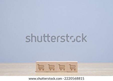 wooden cube with icon shopping cart symbol on wooden table. increase make business grow and Online Shopping concept, sell marketing purchase delivery.