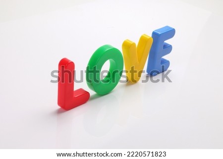 red green blue yellow plastic toy capital font letter alphabet love on white background copy text space concept 