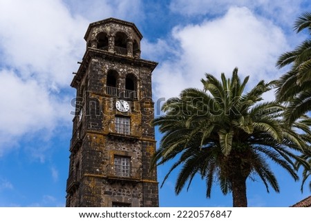 Palm trees and the tower of the historic church Iglesia de la Concepción in San Cristóbal de La Laguna on Tenerife. Royalty-Free Stock Photo #2220576847