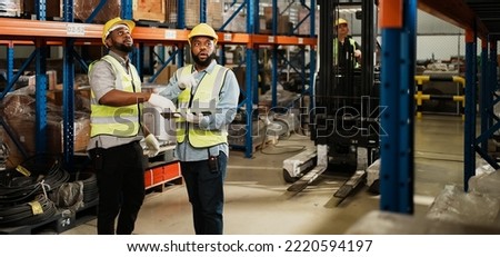 Two warehouse workers checking and controlling boxes in warehouse, Professional warehouse workers moving cardboard boxes by forklift stacker loader, Logistic and business export concept