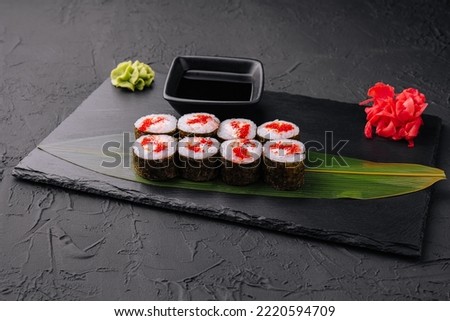 Sushi with red caviar on black stone