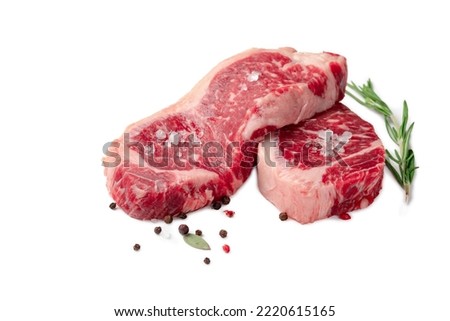 Two juicy raw beef striploin steaks isolated on a white background with herbs and spices Royalty-Free Stock Photo #2220615165