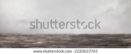 empty wooden table on a grey smoke background. banner
