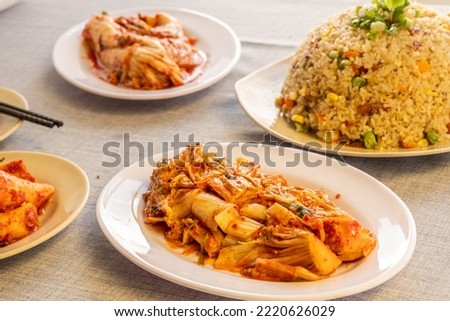 Delicious plate of seafood or grilled meat, fried rice, squid, meat, salad, grilled corn, vegetables, kimchi in traditional korean or vietnam style. Food picture for menu, marketing or design.