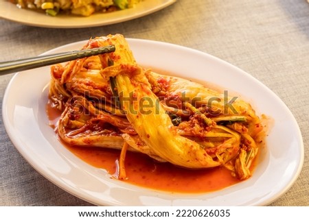Delicious plate of seafood or grilled meat, fried rice, squid, meat, salad, grilled corn, vegetables, kimchi in traditional korean or vietnam style. Food picture for menu, marketing or design.