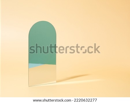 Vertical mirror on a pastel gold background reflecting green surface. Minimal geometric surreal template Royalty-Free Stock Photo #2220632277