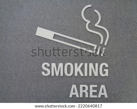 Smoking area sign on the dark grey wall