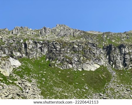 Rocky mountain peaks Poncione di Fieud (2696 m) and Fibbia (2738 m) in the massif of the Swiss Alps above the St. Gotthard Pass (Gotthardpass), Airolo - Canton of Ticino (Tessin), Switzerland (Schweiz Royalty-Free Stock Photo #2220642113
