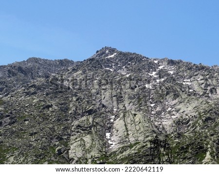 Rocky mountain peaks Poncione di Fieud (2696 m) and Fibbia (2738 m) in the massif of the Swiss Alps above the St. Gotthard Pass (Gotthardpass), Airolo - Canton of Ticino (Tessin), Switzerland (Schweiz Royalty-Free Stock Photo #2220642119