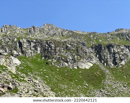 Rocky mountain peaks Poncione di Fieud (2696 m) and Fibbia (2738 m) in the massif of the Swiss Alps above the St. Gotthard Pass (Gotthardpass), Airolo - Canton of Ticino (Tessin), Switzerland (Schweiz Royalty-Free Stock Photo #2220642121