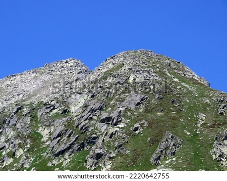 Rocky mountain peaks Poncione di Fieud (2696 m) and Fibbia (2738 m) in the massif of the Swiss Alps above the St. Gotthard Pass (Gotthardpass), Airolo - Canton of Ticino (Tessin), Switzerland (Schweiz Royalty-Free Stock Photo #2220642755