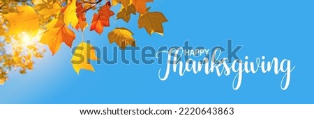 Happy Thanksgiving header, fall panoramic background, sun, yellow maple leaves and blue sky Royalty-Free Stock Photo #2220643863