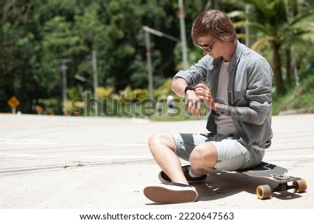 Young adult man with skate board on the road. High quality photo