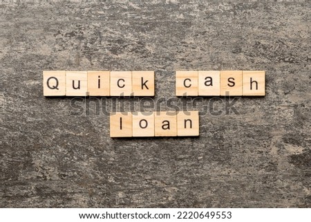 quick cash loan word written on wood block. quick cash loan text on table, concept.