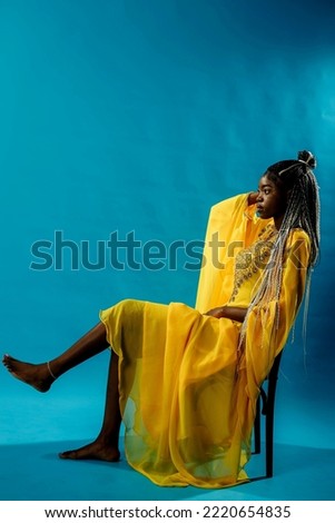 a girl in a yellow dress on a yellow background
