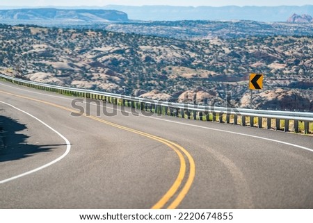 Beautiful winding highway 12 scenic road trip from car point of view in Grand Staircase Escalante National Monument in Utah summer with curve signs and views