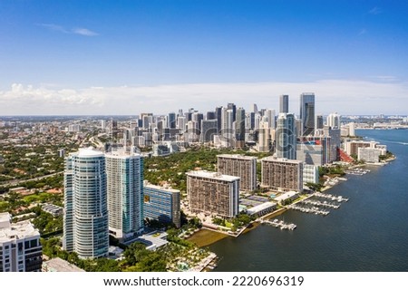Drone aerial shot of bahia miami, with towers and modern buildings, , neighborhood, palms, trees, streets, bay, pier, boats, sea, blue sky