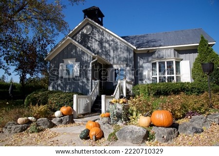Halloween decoration with pumpkins on a Victorian-style house  Royalty-Free Stock Photo #2220710329