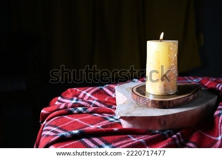 candle on wooden board isolated on dark background